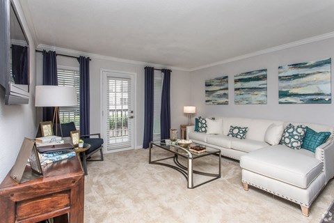 a living room with a white couch and a table